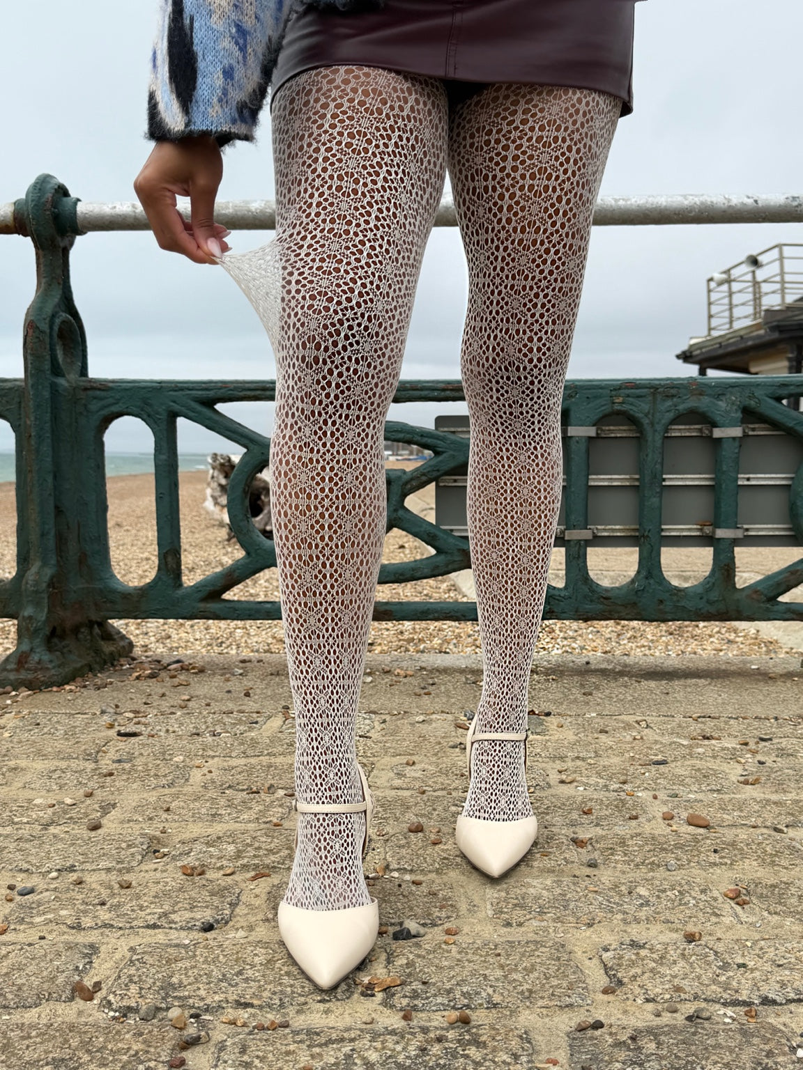 Model wearing off-white Lace Loop openwork tights with cream pointed shoes